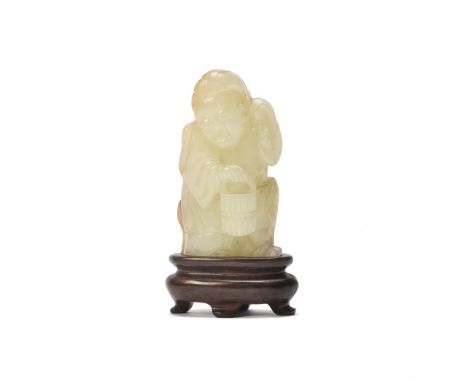 A Chinese white and russet jade figure of Zhou Tanzi, 17th-18th century, the boy, Tanzi, is shown holding a bucket as he stan