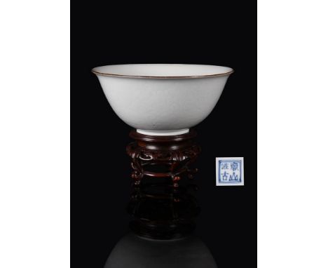 A rare Chinese porcelain 'Lotus' bowl, Kangxi, white body and blue-toned glaze, brown line rim, the exterior with incised lot