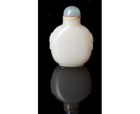 A Chinese pale celadon jade snuff bottle, Qing Dynasty, 19th century, the flattened bottle carved on either side with lion-ma