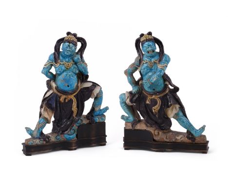Two large Chinese large blue and aubergine Fehua-glazed 'heavenly guardian' pottery tile-figures, Ming Dynasty, fitted on ebo