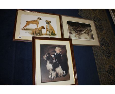 Three framed and mounted prints  including a young boy with his pet spaniel, a Robert J. May print of four dogs and a limited