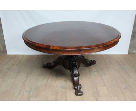 19th century rosewood centre table, with circular tilt top raised on bulbous carved column and spread carved tripod supports,