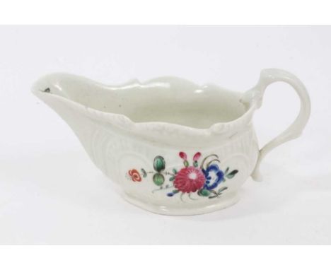 A Pennington Liverpool cream boat, polychrome painted with floral sprays, with scrollwork moulding, 13cm from spout to handle