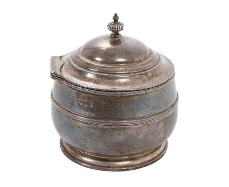 George V silver tea caddy of cauldron form with central band of reeded decoration, hinged domed cover, with fluted finial, on