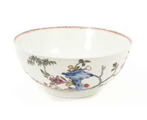 An English porcelain bowl attributed to Vauxhall, circa 1755, polychrome painted in the Chinese style with flowers issuing fr