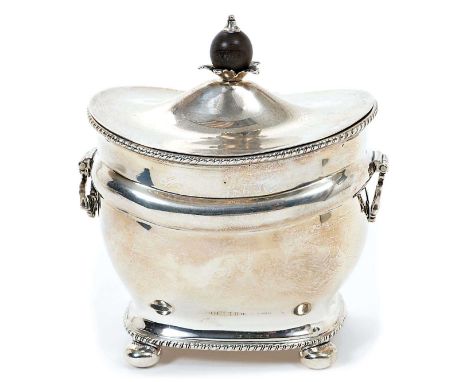 Edwardian silver tea caddy of bombe form, with gadrooned borders and hinged domed cover, with turned wood finial, on four bun