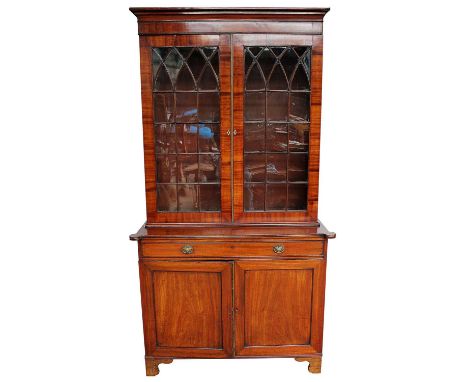 Early 19th century mahogany two height bookcase, the upper section with moulded cornice and enclosed by pair of gothic astrag