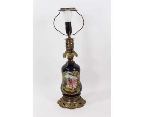 Continental porcelain table lamp, with gilt metal mounts and overpainted transfer print reserves of figures, raised on elabor