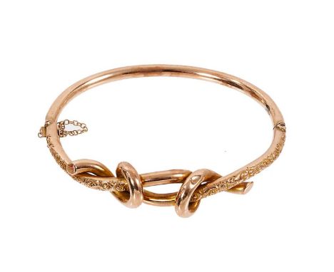 Victorian 9ct rose gold hinged bangle with stylised 'lover's knot' and foliate decoration, marked '9c'.Good condition commens