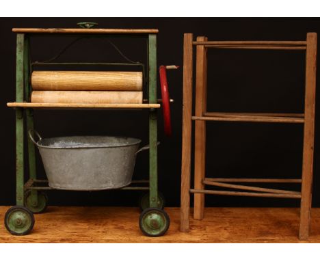 A 1950's Tri-ang child's small-scale mangle/wringer, green metal frame with red winding handle and wooden rollers, 51cm high;