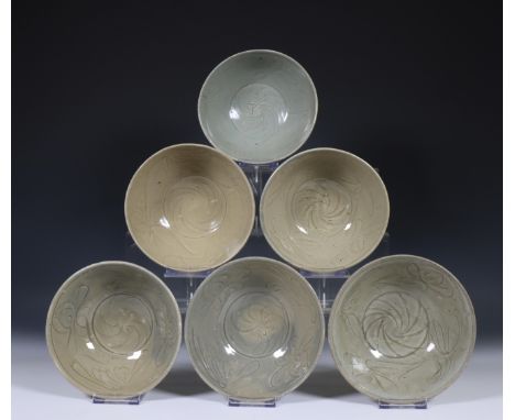 China, six deep celadon glazed bowls, Northern Sung dynasty, 10th-12th century, with flowing floral decoration, covered with 
