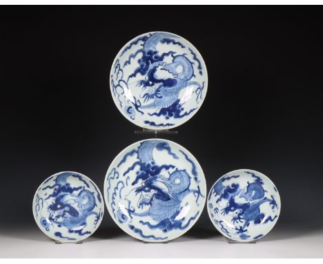 Japan, two pairs of blue and white porcelain 'dragon' dishes, 19th century, each painted with a dragon chasing the flaming pe