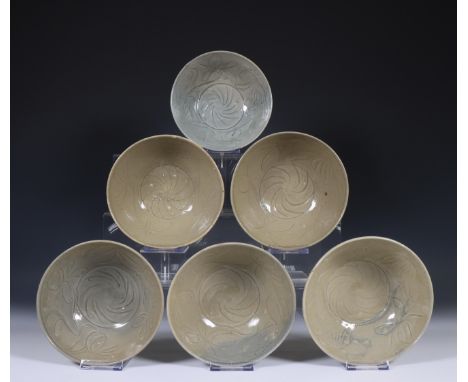 China, six deep celadon glazed bowls, Northern Sung dynasty, 10th-12th century, with flowing floral decoration, covered with 