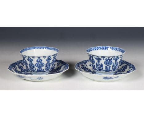 China, pair of canted blue and white porcelain teacups and saucers, Kangxi period (1662-1722), decorated with a stylised flor