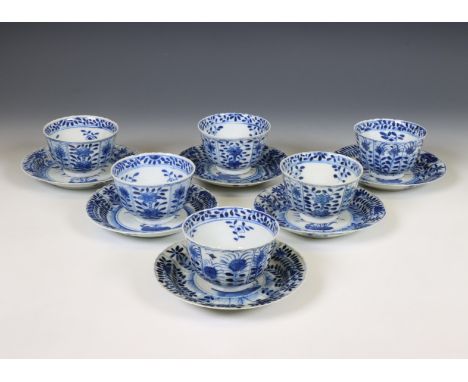China, set of six blue and white porcelain teacups and saucers, 19th century, each painted in the Kangxi style with flowers, 