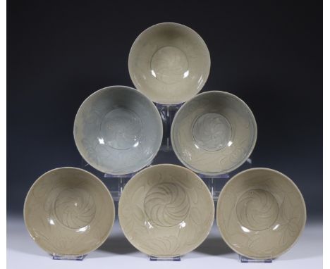 China, six deep celadon glazed bowls, Northern Sung dynasty, 10th-12th century, with flowing floral decoration, covered with 