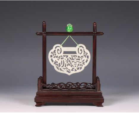 China, jade pendant in wooden frame, 19th century, the pale green pendant of ruyi-head shape and openworked with floral motif