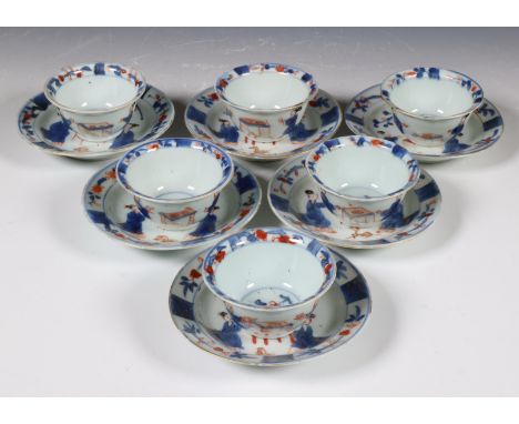 China, set of six Imari porcelain cups and saucers, 18th century, each painted with a pair of ladies at a table, a dog in fro