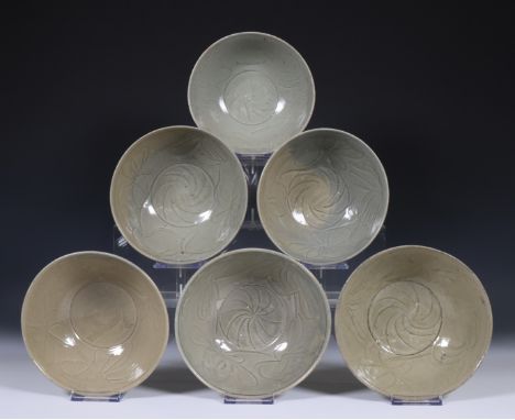 China, six deep celadon glazed bowls, Northern Sung dynasty, 10th-12th century, with flowing floral decoration, covered with 