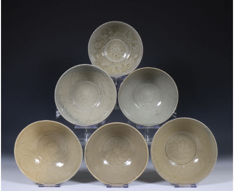 China, six deep celadon glazed bowls, Northern Sung dynasty, 10th-12th century, with flowing floral decoration, covered with 
