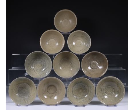 China, ten celadon glazed bowls, Northern Sung dynasty, 10th-12th century, with stylised floral decoration, covered with vary