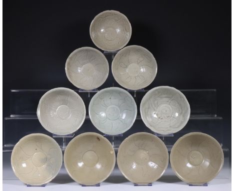 China, ten celadon glazed bowls, Northern Sung dynasty, 10th-12th century, with sculpted rim and stylised floral decoration, 