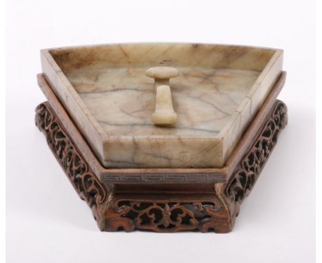 China, jade dish, 19th century, the lozenge-shaped dish centred by a ruyi-sceptre, the veined stone of a pale green and brown