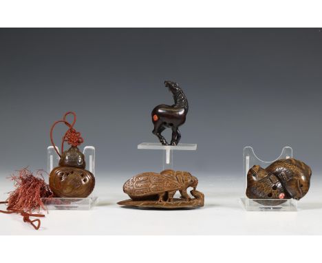 Japan, three wood netsuke and a soapstone snuff-bottle mounted as a pendant, late 19th-20th century, comprising a netsuke car