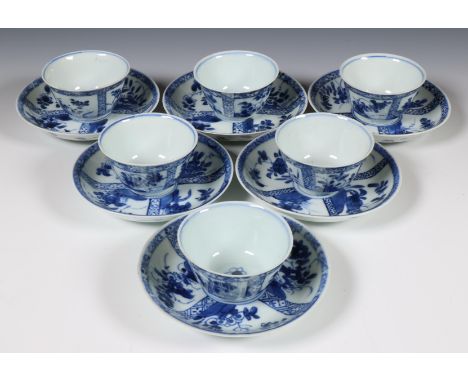 China, set of six blue and white porcelain cups and saucers, 18th century, decorated with panels of flowers (one cup and two 