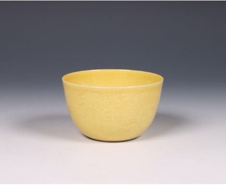 China, yellow-glazed sgraffito porcelain 'dragon' cup, 20th century, the sides incised with dragons chasing the flaming pearl