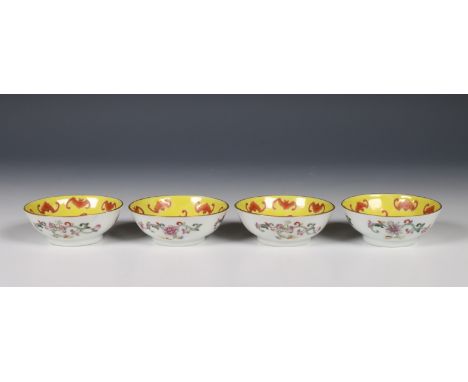 China, set of four yellow-ground small saucers, 20th century, decorated in iron-red with bats, four-character marks to the ba