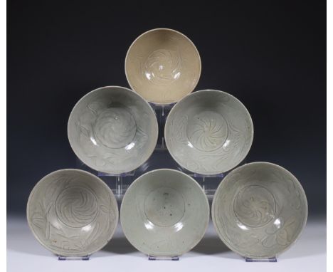 China, six deep celadon glazed bowls, Northern Sung dynasty, 10th-12th century, with flowing floral decoration, covered with 