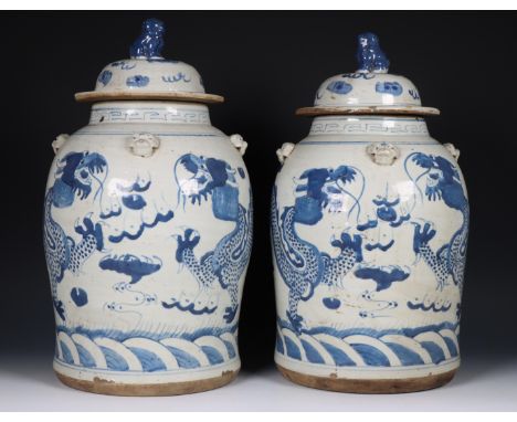 China, pair of blue and white 'dragon' jars and covers, 19th century, each painted with a air of dragons contesting the flami