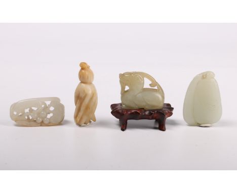 China, six small jade carvings, comprising a kylin on wood stand, two feline groups, a double-gourd, a vine and a hand citron