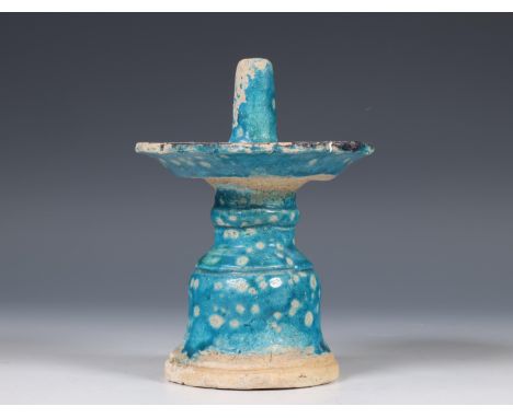 China, a turquoise-glazed earthenware candlestick, Ming dynasty (1368-1644), the base of bell shape, supporting a circular pr