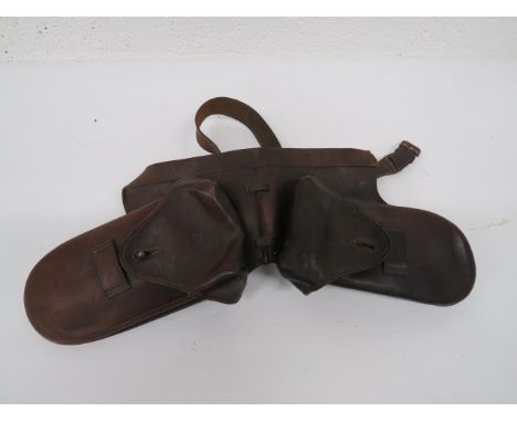 Cavalry Officer's Saddle Wallets brown leather pockets.  Top flaps secured by chrome studs.  Interior cloth lining.  Wide lea