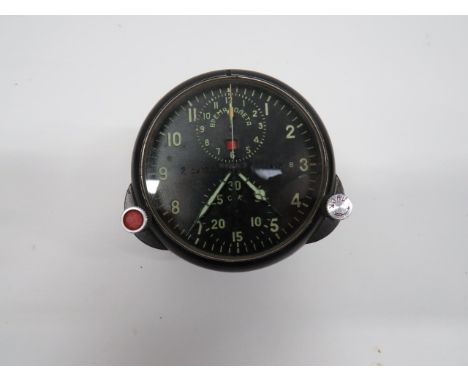 Russian Mig Fighter Clock black face with luminous hands and numerals.  The face with upper and lower operating dials.  Exter