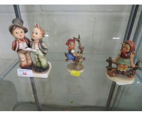 A HUMMEL FIGURE GROUP OF CAROL SINGERS, A HUMMEL FIGURE OF GIRL SAT IN TREE AND FIGURE OF GIRL SAT ON FENCE.