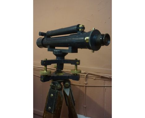 Surveyors Theodolite by Hutchison &amp; Co Edinburgh, raised on a wooden tripod stand, also with surveying height measure and