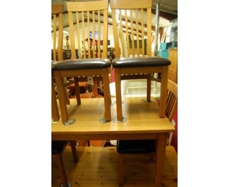 A contemporary light oak dining suite comprising rectangular dining table, length 138cm; and a set of six conforming slatback