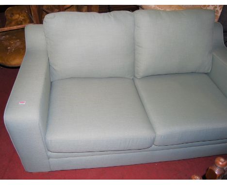 A contemporary sky-blue upholstered two seater sofa, with matching hinged footstool (2)