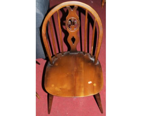 A pair of blond Ercol stickback kitchen chairs, together with a further pair of Ercol dark elm stickback kitchen chairs (4)