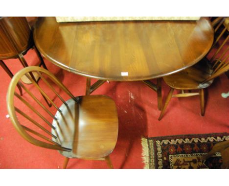 An Ercol dark elm drop-flap breakfast table, together with a matching set of four stickback chairs (5)