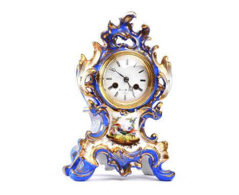 FRENCH PROCELAIN MANTLE CLOCK WITH A CIRCULAR PORCELAIN DIAL OF 3 INCHES.EXOTIC BIRD DESIGN.K.W. MARE, PARIS. HEIGHT: 11 INCH