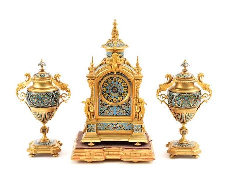 GILT METAL AND CLOISONNE MANTLE CLOCK WITH CHERUB MOUNTED PILLARS AND PIERCED TOP ON A GILT WOOD SHAPED BASE WITH MATCHING GI