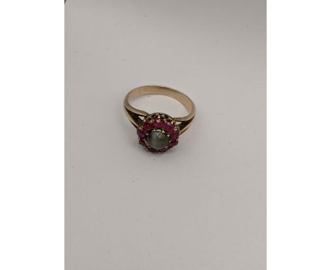 A yellow metal ruby and cabochon centre ring, size N 1/2, 3.8gLocation: 