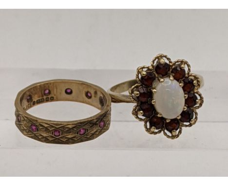 A 9ct gold ring inset with an oval opal and garnets, total weight 3.8g, together with a 9ct gold ring set with rubies 2.8g, t