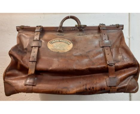 A vintage large brown leather Gladstone cruise cabin bag having a cloth interior, 4 leather corners with 4 brass studs, 2 bra