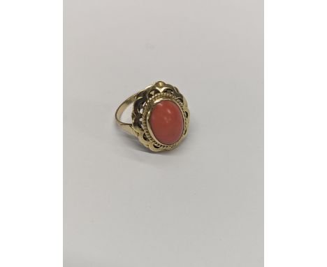 A vintage yellow metal ring inset with a central and cabochon cord with ornate yellow metal surrounding mount, size 0, 4.1gLo