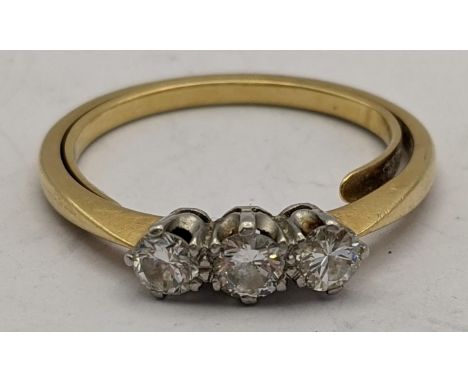 A yellow metal ring set with three diamonds 3.8gLocation: 